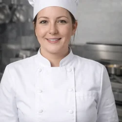 Chef Harper presenting hearty meat dishes in a professional kitchen